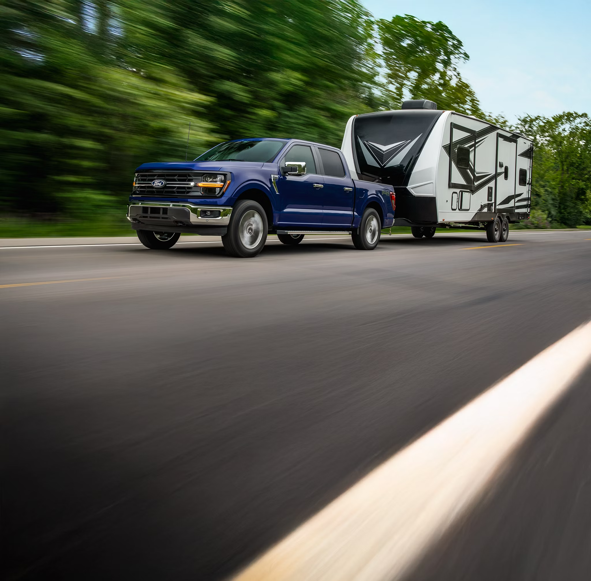 2026 Ford F-150 towing a camper trailer